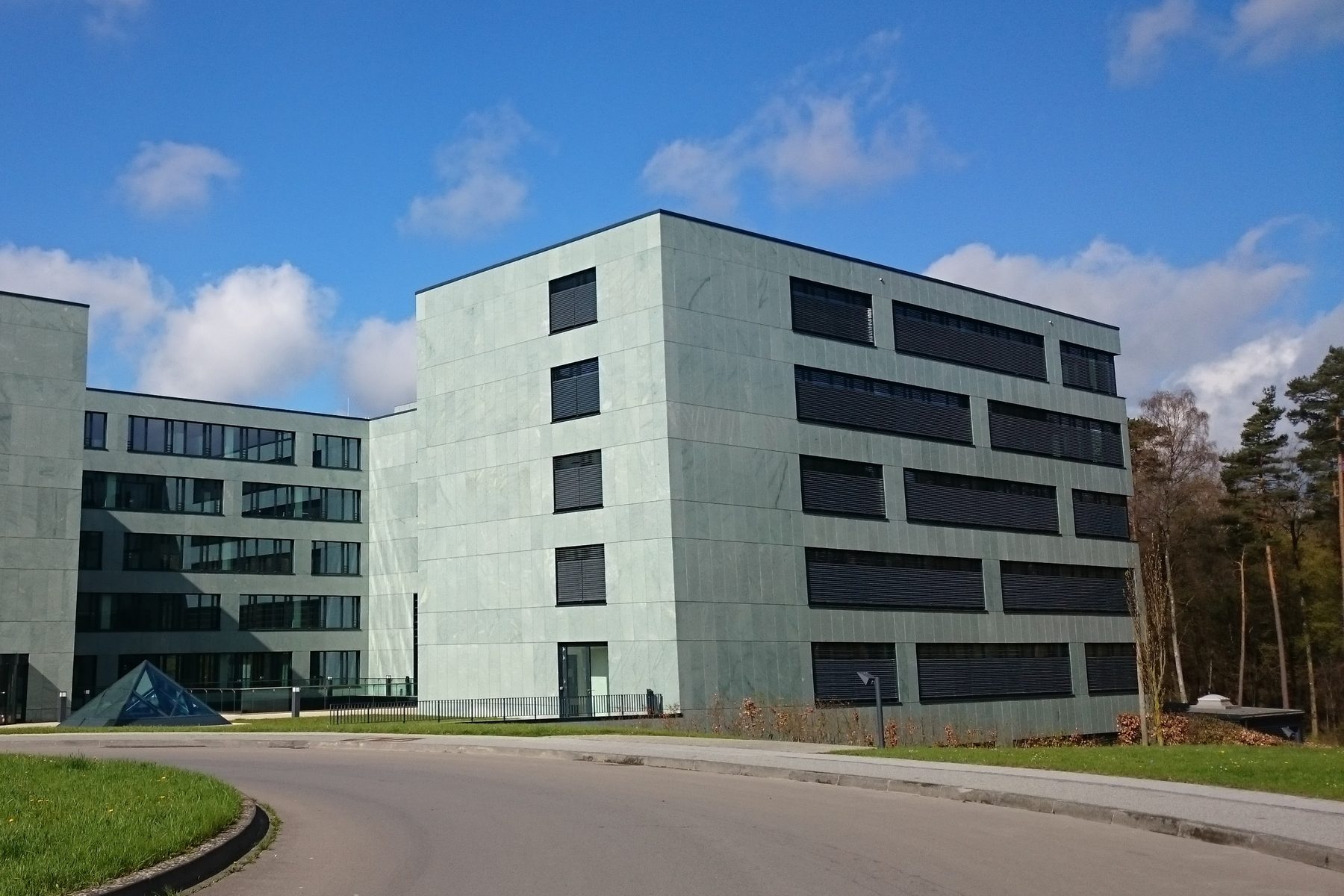A modern office building in Luxembourg under a blue sky